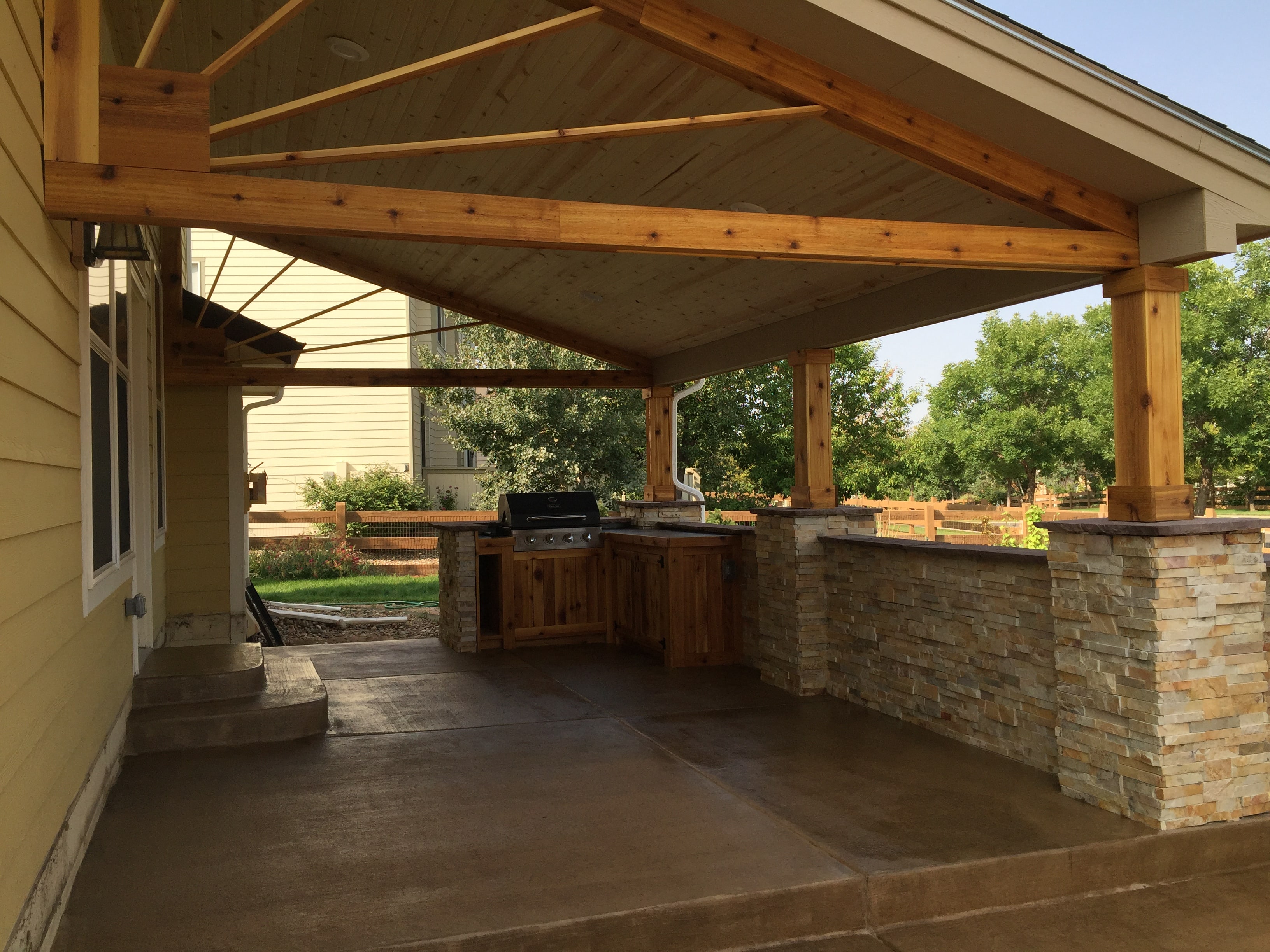 Norstone Aztec XLX Stacked Stone veneer panels used on a large outdoor kitchen with roof